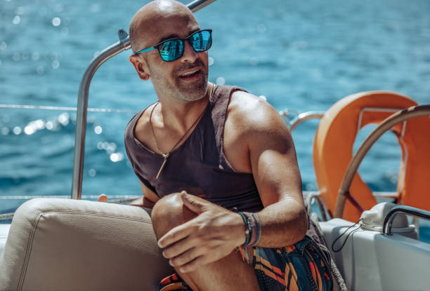 istock Happy Man on Sailboat 1421353454