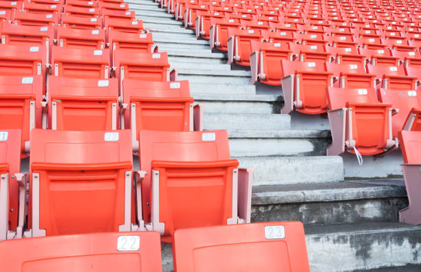 istock Empty orange seats at stadium,Rows of seat on a soccer stadium 1421355241