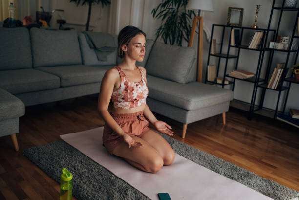 istock Woman doing yoga at home 1421357348