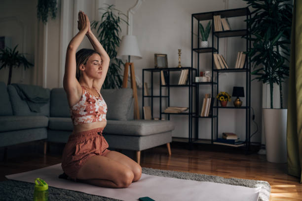 istock Woman doing yoga at home 1421357377