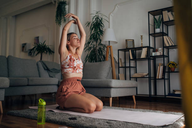 istock Woman doing yoga at home 1421357932
