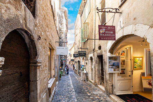 Shops and art galleries line the narrow cobblestone roads in the medieval hilltop village of Saint Paul de Vence, France, on the French Riviera.