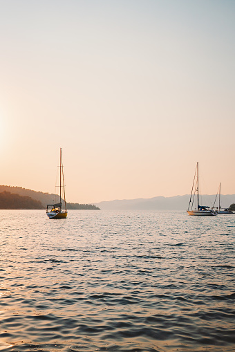 Yachts sailing in Aegean sea sunset view beautiful landscape travel yachting tour summer vacations