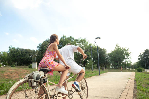 Young couple with bicycle in a summer Italian city