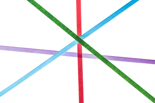 colored paper lines intersecting on white