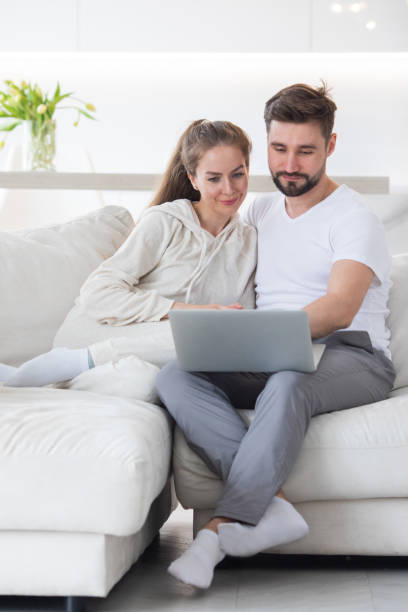 istock Happy married couple with laptop 1421366439