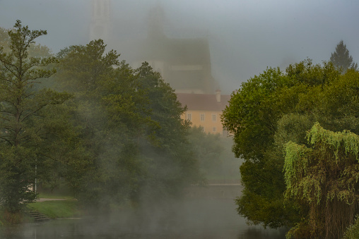 Ludwig-Donau-Main-Kanal, Essing, Bavaria, Germany, with colorful trees at misty day, vanishing point