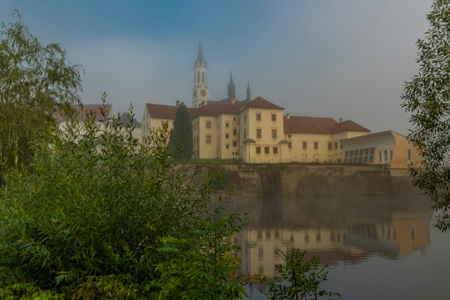 Vyssi Brod town in summer foggy morning with color buildings and fresh nature