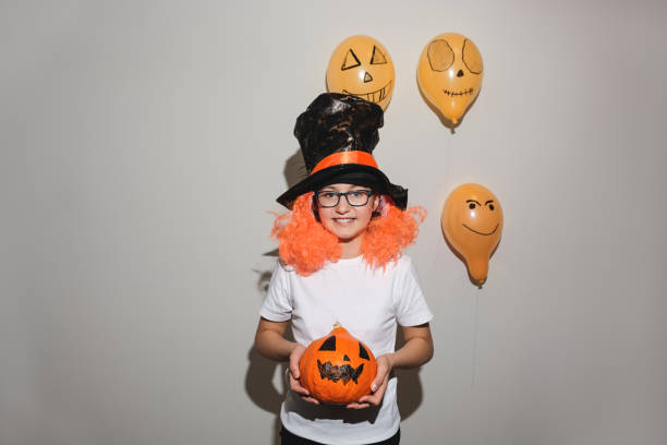 ragazza di halloween che tiene la zucca - pumpkin small orange holiday foto e immagini stock