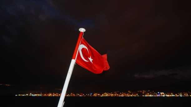 istock Turkish flag brightened during night with city lights in the background 1421371907