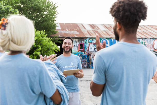 istock Volunteer group clapping for their team lead 1421375956