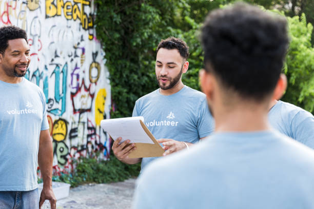 istock Young adult male reads paperwork 1421375968