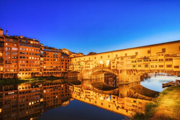 istock Illuminated Ponte Vecchio Bridge with Reflection in Arno River at Dusk, Florence 1421376282