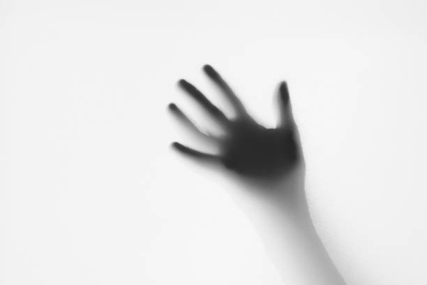 istock Hand silhouette behind frosted glass 1421378051