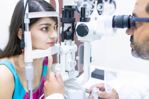 istock Using a biomicroscope to evaluate the patient's eyes. 1421378056