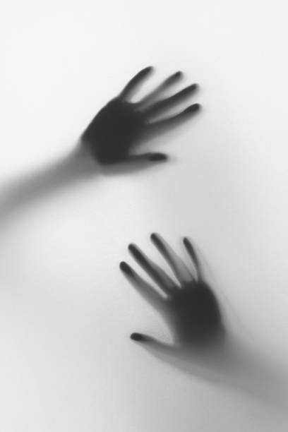 istock Hand silhouette behind frosted glass 1421378130