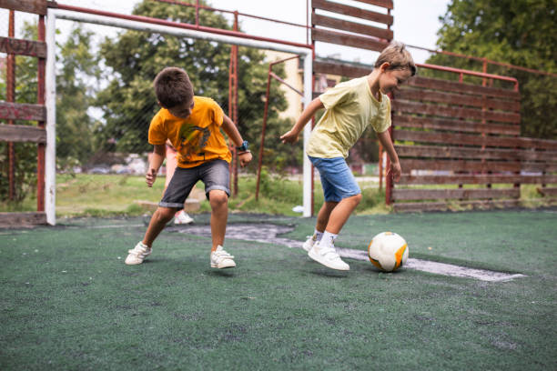 istock Fun at the school soccer pitch 1421378328