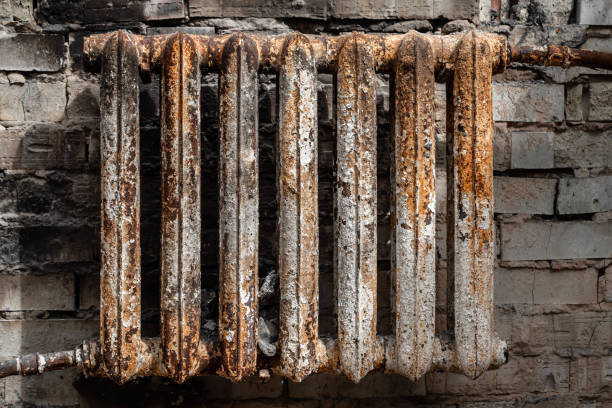 istock A rusty cast-iron battery in a burnt-out house 1421378369