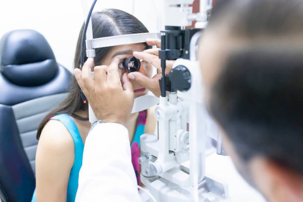 istock Doctor using an external lens for pupil dilation 1421379156