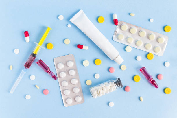 istock medicines, ointment, syringe, ampoules, tablets are laid out on a blue background 1421380789