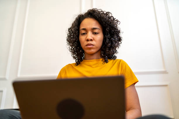 istock Afro-American woman working on her laptop 1421382249
