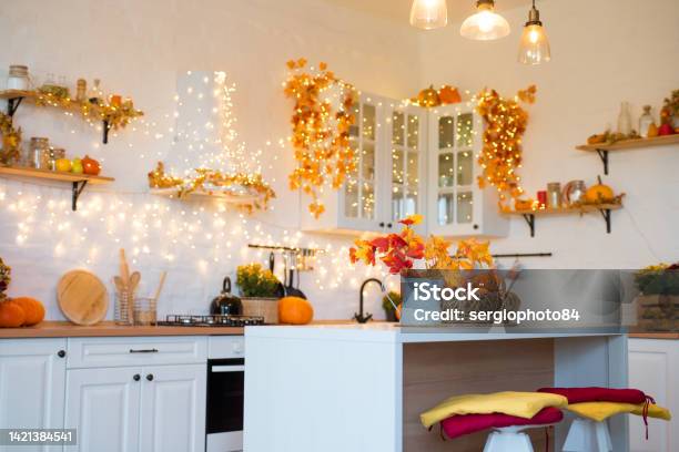 Autumn Kitchen Interior Red And Yellow Leaves And Flowers In The Vase And Pumpkin On Light Background Stock Photo - Download Image Now