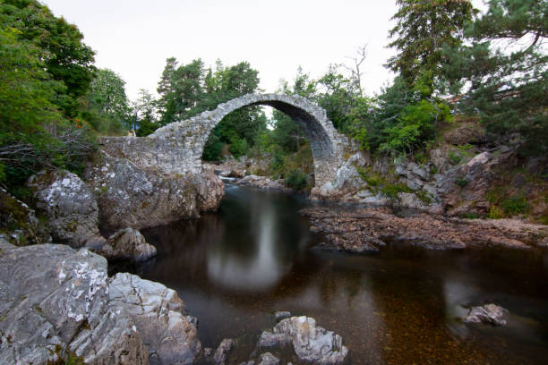 Carrbridge historical packhorse bridge in Cairngorms Scotland Carrbridge historical packhorse bridge in Cairngorms Scotland cairngorm mountains stock pictures, royalty-free photos & images