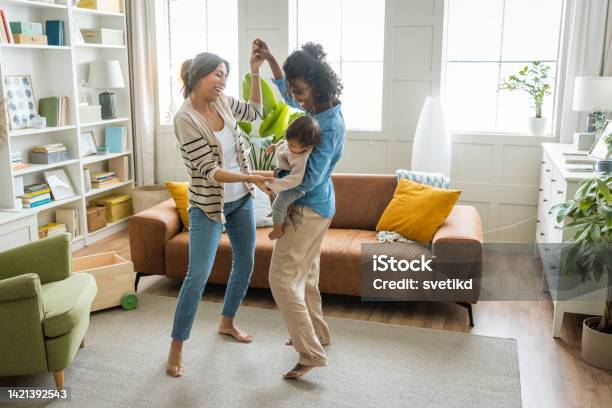 Female Gay Couple With Baby At Home Stock Photo - Download Image Now - Dancing, Baby - Human Age, Lesbian