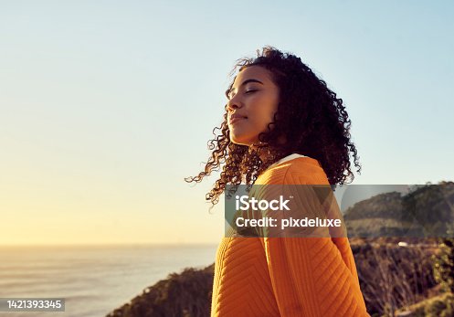 istock Freedom, relax and happy mindset of a woman from Brazil with sun on her face at a sea. Nature, ocean and beach water sunset with a young person feeling peace, wellness and gratitude from meditation 1421393345