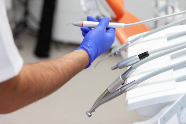 istock Gloved hand takes a dental drill. Dentist workflow 1421396766