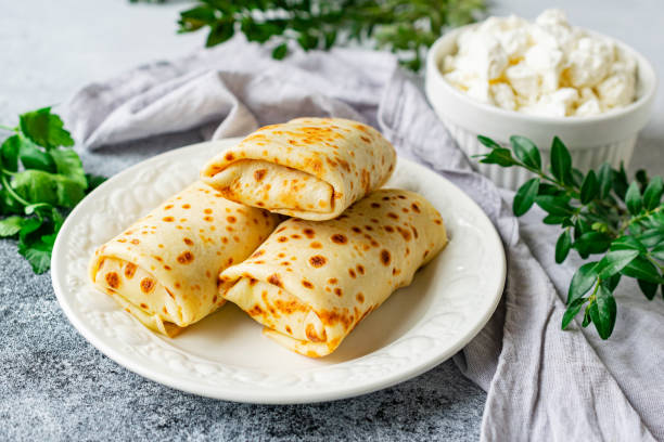 istock Pancakes stuffed with cottage cheese and herbs on a white plate 1421398984