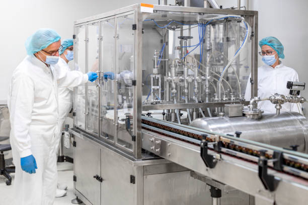 istock Three fully equipped coworkers in protective workwear seen in a pharmaceutical laboratory 1421401825