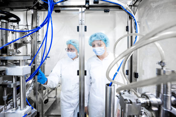 istock Two fully equipped coworkers in protective workwear seen in a pharmaceutical laboratory 1421402531