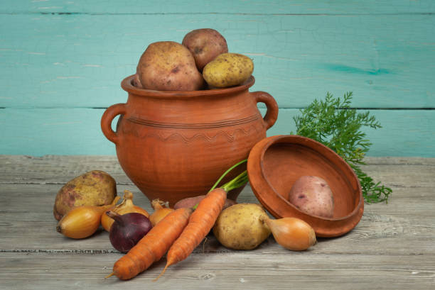 Assortment of organic root vegetables for cooking simple rustic food soup in earthenware