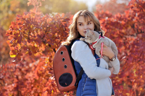 istock Waman with a pet carrier backpack looking back against the autumn background 1421407799
