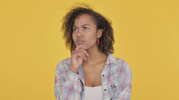 istock Pensive Young African Woman Thinking and getting Idea on Yellow Background 1421411549