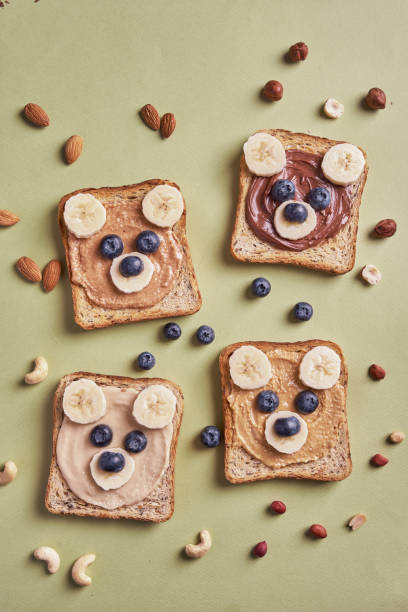 istock Funny children bear toasts with nuts butters 1421411960