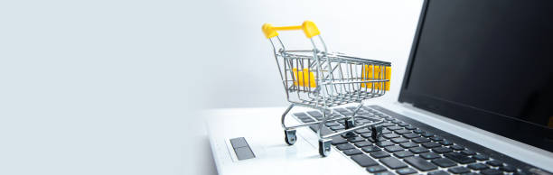 istock Laptop keyboard with supermarket trolley 1421413739