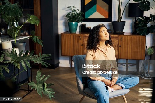 istock Peace, relax and happy mindset of a woman from Indonesia taking a mind and meditation home break. Happiness of woman on a house living room lounge chair thinking about life, gratitude and self care 1421420537