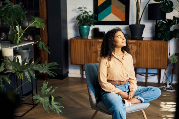 Peace, relax and happy mindset of a woman from Indonesia taking a mind and meditation home break. Happiness of woman on a house living room lounge chair thinking about life, gratitude and self care Peace, relax and happy mindset of a woman from Indonesia taking a mind and meditation home break. Happiness of woman on a house living room lounge chair thinking about life, gratitude and self care meditating stock pictures, royalty-free photos & images