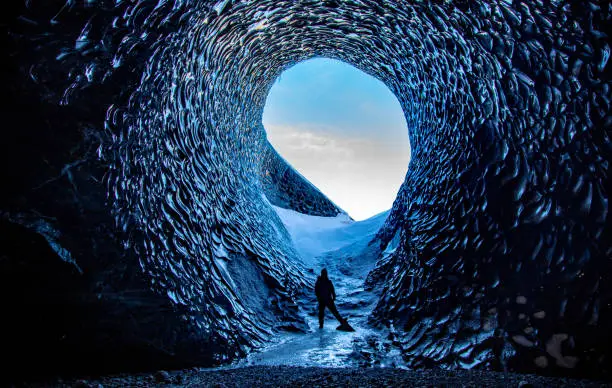 Ice Cave Tunnel in Iceland with ice formations appearing to look like snakeskin. Locally referred to as Anaconda.