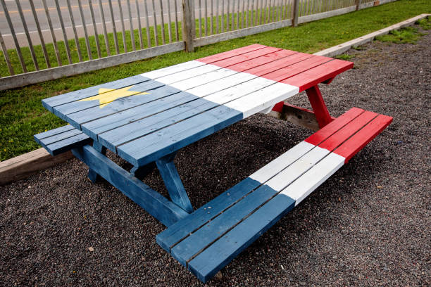 A picnic table painted with the Acadian Flag