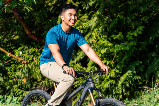 istock Man Riding Bike on Path at Park 1421423488