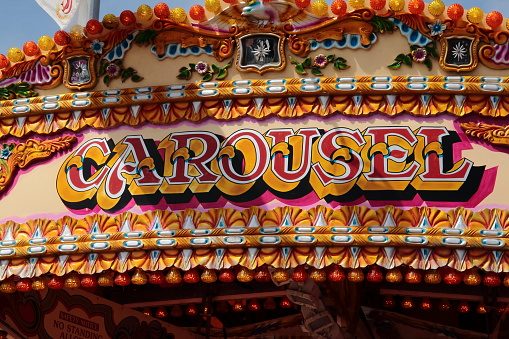 UK, 2016: Colourful image of Carousel top