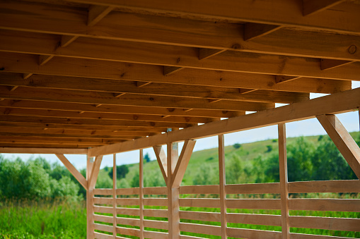 Roof of beams in a wooden gazebo under a canopy