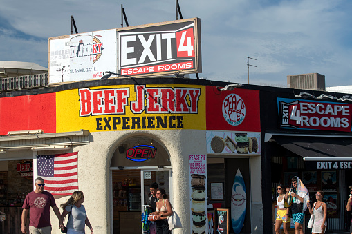 Ocean City, USA - September 3, 2022. Tourists walking past Beef Jerky Experience store in Ocean City, New Jersey, USA