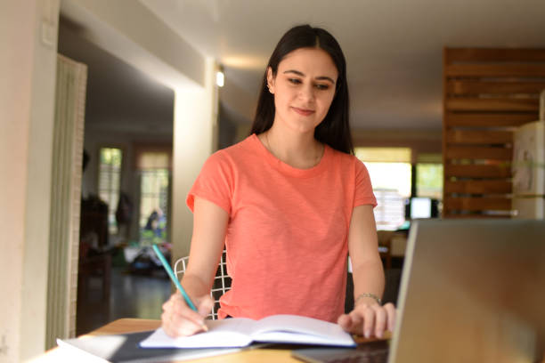 istock woman studying at home 1421436451