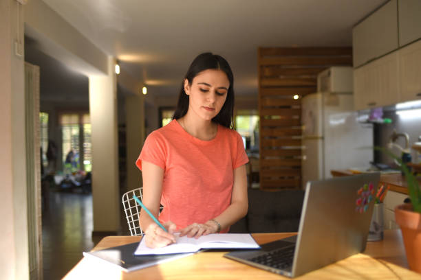 istock woman studying at home 1421436475