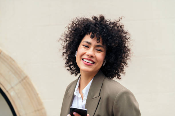 istock woman with earphones smiling looking at camera 1421439113