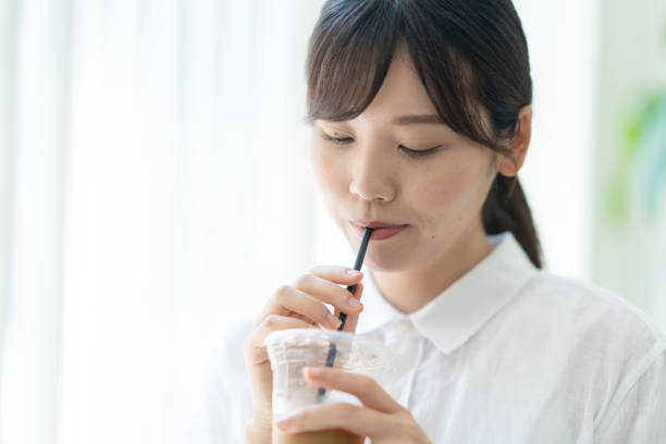 istock Japanese woman drinking coffee in a cafe 1421442022